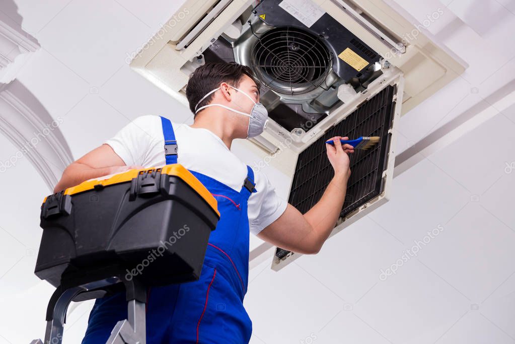 Technician performing AC maintenance
