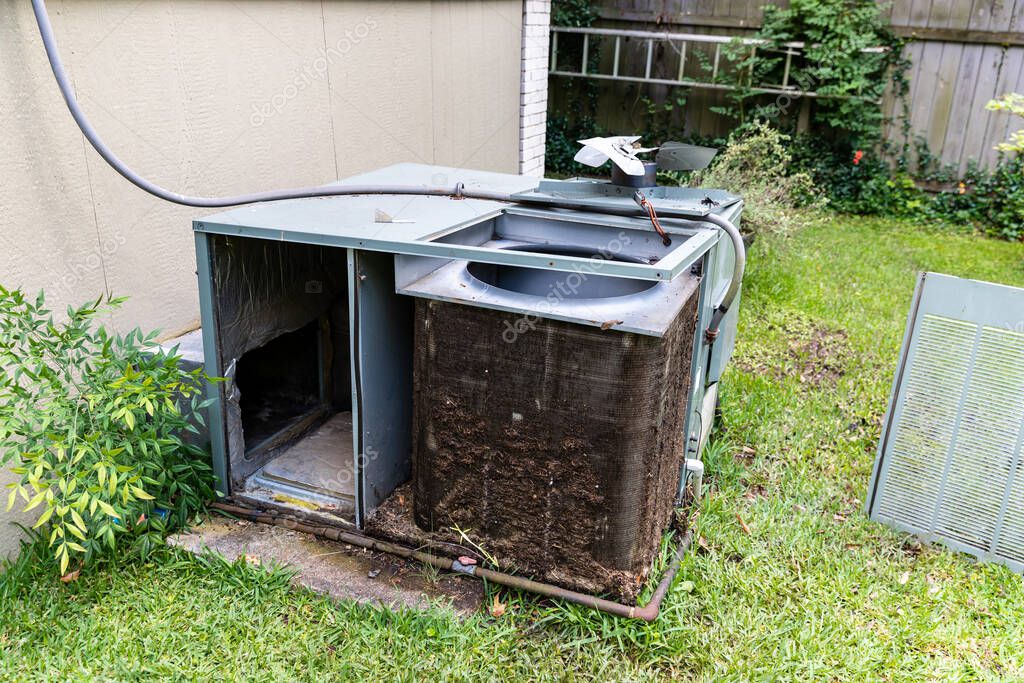 Technician cleaning an AC evaporator coil