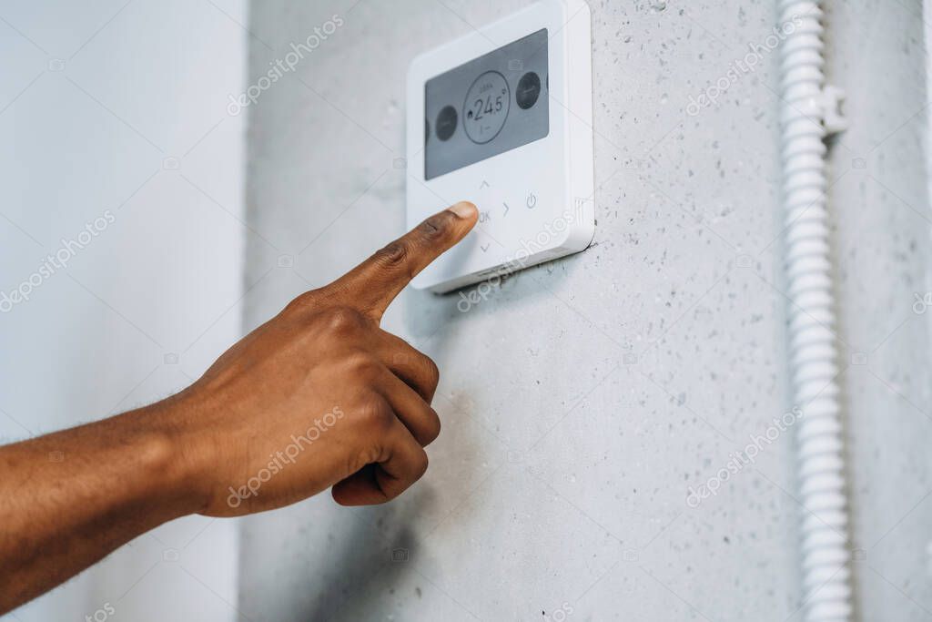 Smart thermostat on wall being configured